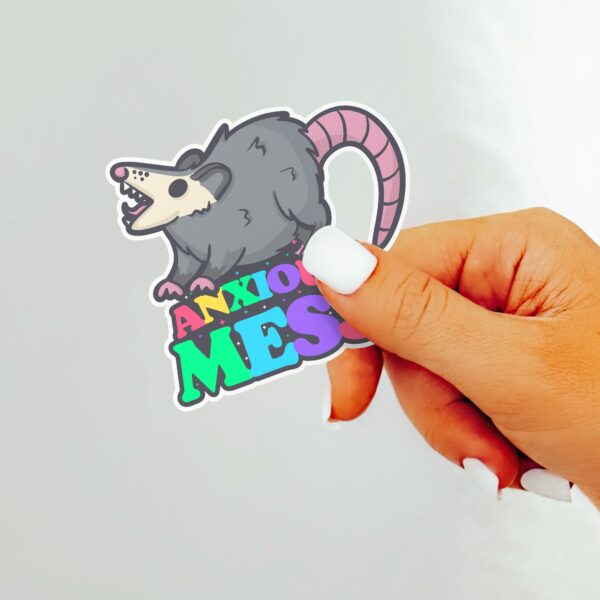 This image shows our adorable sticker finishes, Anxious Mess Possum Sticker, which is available to purchase from HunnieByte.com