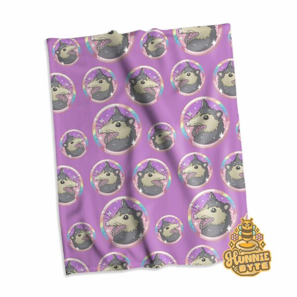 This image shows our Rainbow Possum Blanket, which is available to purchase from HunnieByte.com