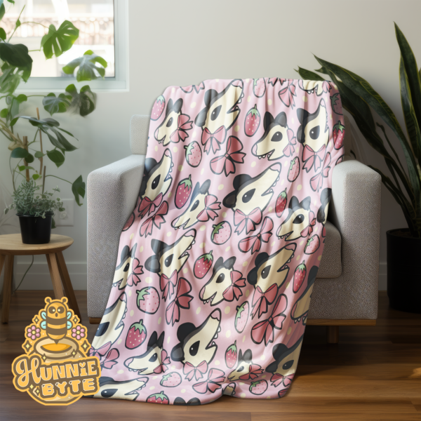 This image shows our Strawberry Possum Blanket, which is available to purchase from HunnieByte.com