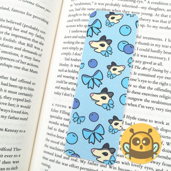 This image shows an hand-drawn adorable bookmark, Blueberry Possum Bookmark, which is available to purchase from HunnieByte.com