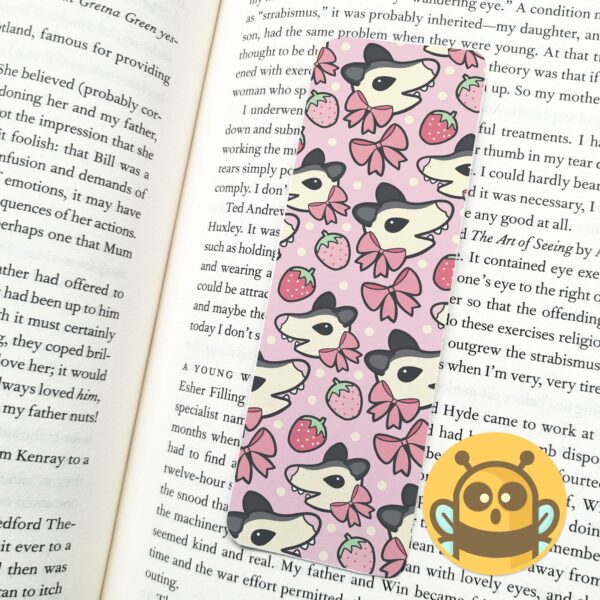 This image shows an hand-drawn adorable bookmark, Strawberry Possum Bookmark, which is available to purchase from HunnieByte.com