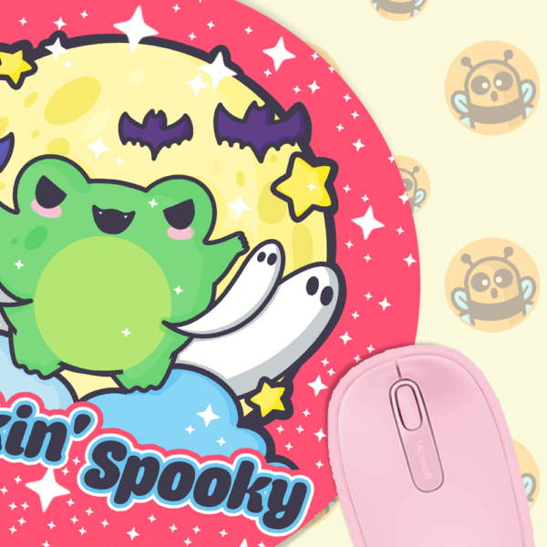 This image shows an hand-drawn adorable mousepad, Heckin Spooky Frog Mousepad, which is available to purchase from HunnieByte.com