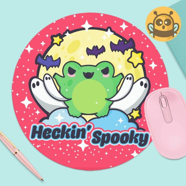 This image shows an hand-drawn adorable mousepad, Heckin Spooky Frog Mousepad, which is available to purchase from HunnieByte.com