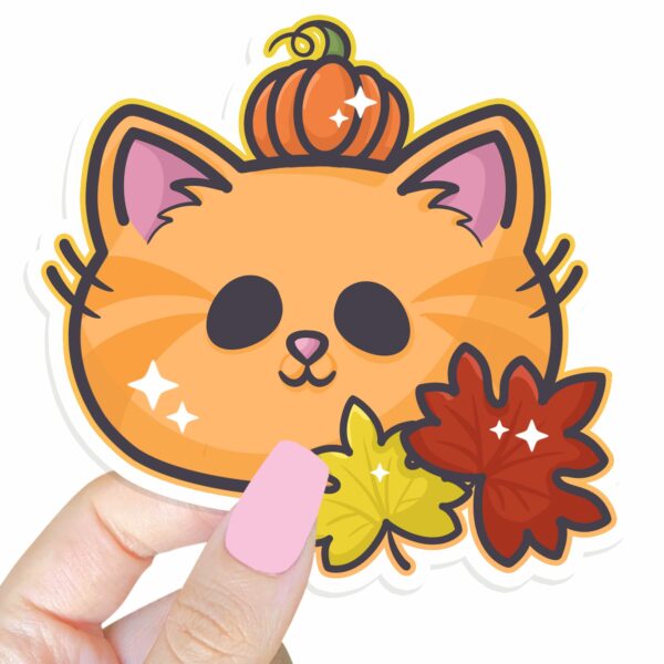 This image shows an hand-drawn adorable sticker, Autumn Pumpkin Kitty Sticker, which is available to purchase from HunnieByte.com