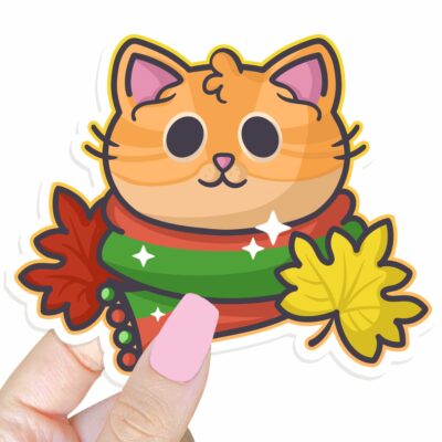 This image shows an hand-drawn adorable sticker, Autumn Ginger Kitty Sticker, which is available to purchase from HunnieByte.com