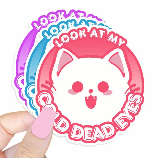 This image shows our adorable sticker finishes, Look At My Cold Dead Eyes Cat Sticker, which is available to purchase from HunnieByte.com