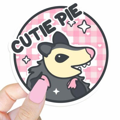 This image shows an hand-drawn adorable sticker, Cutie Pie Possum Sticker, which is available to purchase from HunnieByte.com