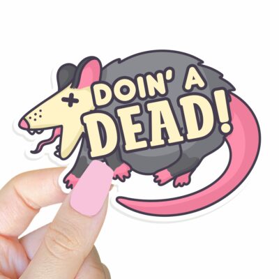 This image shows our adorable sticker finishes, Doin A Dead Possum Sticker, which is available to purchase from HunnieByte.com