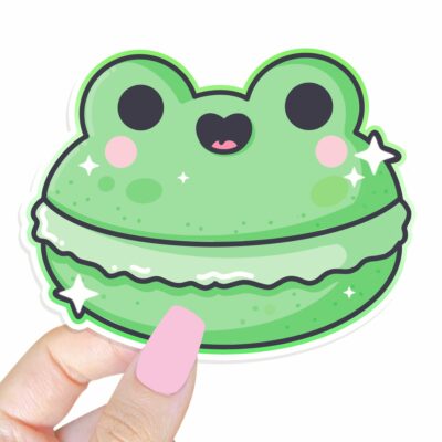 This image shows an hand-drawn adorable sticker, Frog Macaroon Sticker, which is available to purchase from HunnieByte.com