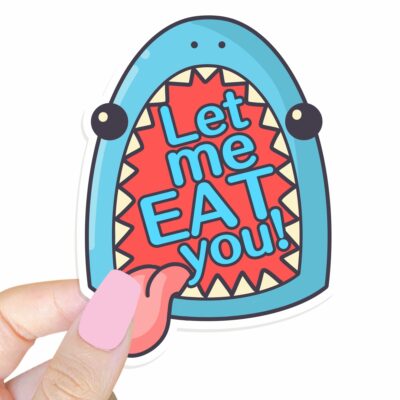 This image shows our adorable sticker finishes, Let Me Eat You Shark Sticker, which is available to purchase from HunnieByte.com