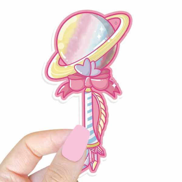 This image shows an hand-drawn adorable sticker, Saturn Magical Wand Sticker, which is available to purchase from HunnieByte.com