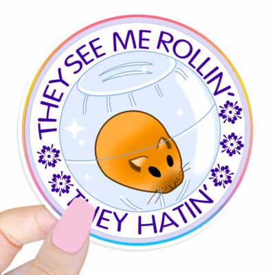 This image shows an hand-drawn adorable sticker, They See Me Rollin Hamster Sticker, which is available to purchase from HunnieByte.com