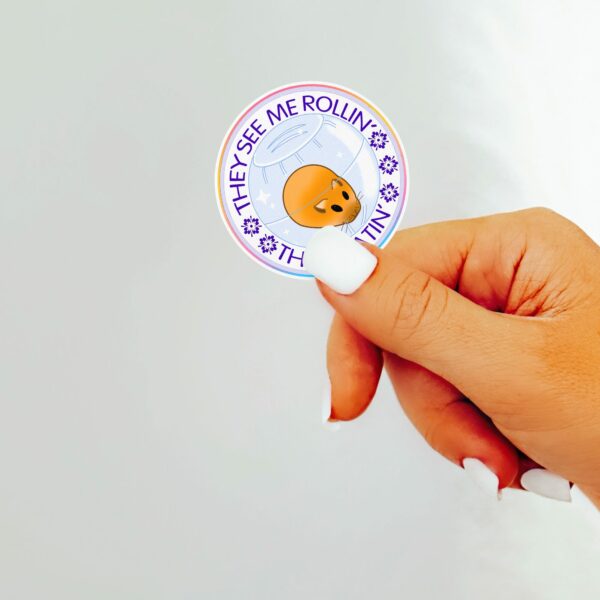 This image shows an hand-drawn adorable sticker, They See Me Rollin Hamster Sticker, which is available to purchase from HunnieByte.com