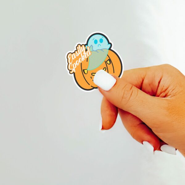 This image shows an hand-drawn adorable sticker, Easily Spooked Ghost Sticker, which is available to purchase from HunnieByte.com