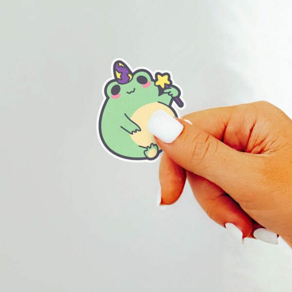 This image shows an hand-drawn adorable sticker, Magical Frog Boi Sticker, which is available to purchase from HunnieByte.com