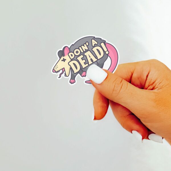 This image shows our adorable sticker finishes, Doin A Dead Possum Sticker, which is available to purchase from HunnieByte.com