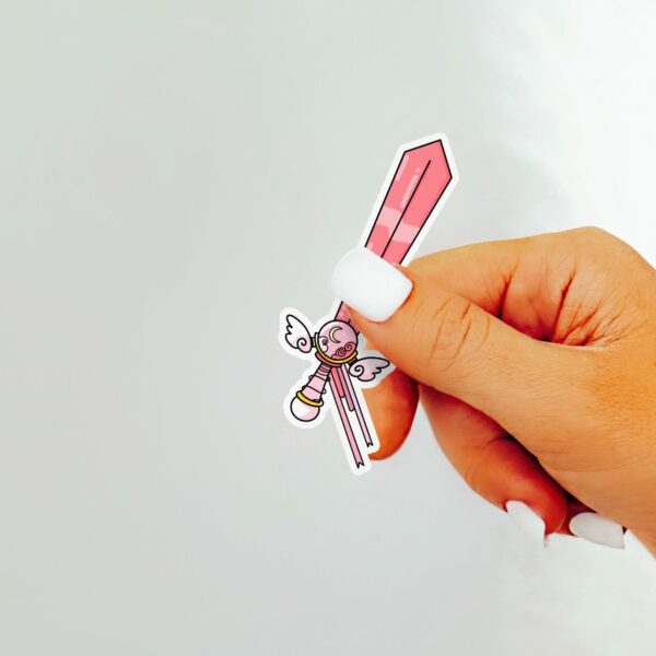 This image shows an hand-drawn adorable sticker, Pretty Pink Magical Sword Sticker, which is available to purchase from HunnieByte.com