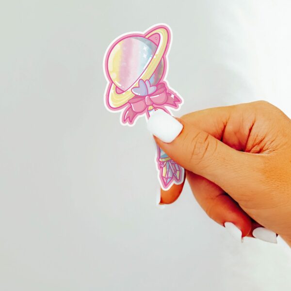 This image shows an hand-drawn adorable sticker, Saturn Magical Wand Sticker, which is available to purchase from HunnieByte.com