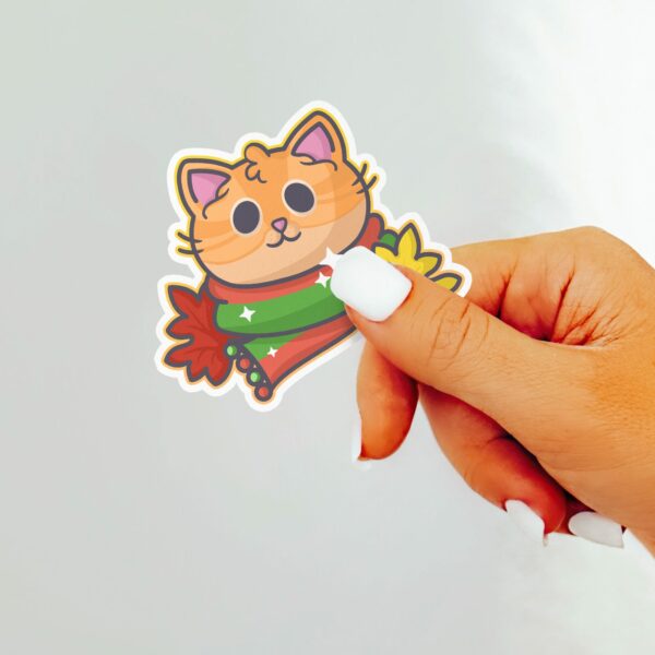 This image shows an hand-drawn adorable sticker, Autumn Ginger Kitty Sticker, which is available to purchase from HunnieByte.com