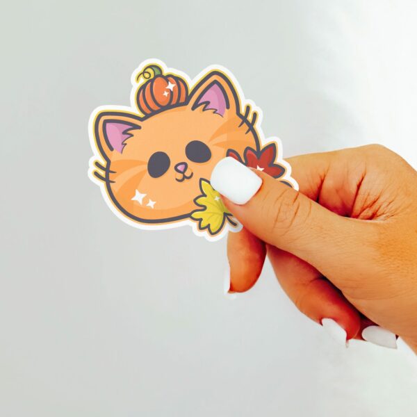 This image shows an hand-drawn adorable sticker, Autumn Pumpkin Kitty Sticker, which is available to purchase from HunnieByte.com