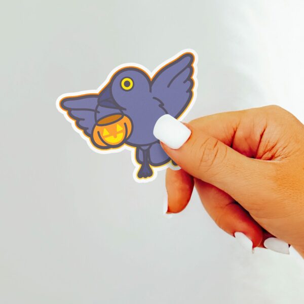 This image shows an hand-drawn adorable sticker, Crow and Pumpkin Sticker, which is available to purchase from HunnieByte.com