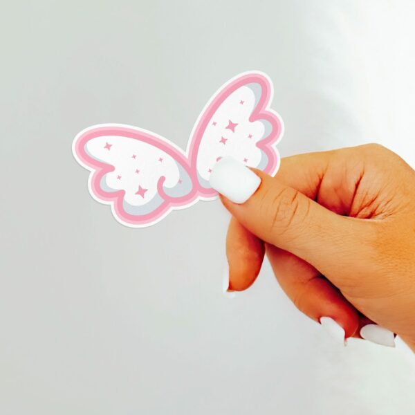 This image shows an hand-drawn adorable sticker, Cute Cloud Wings Sticker, which is available to purchase from HunnieByte.com