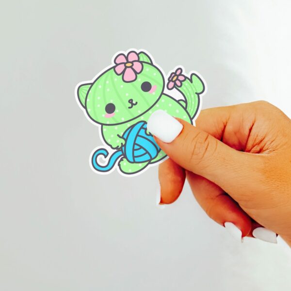 This image shows an hand-drawn adorable sticker, Cacticat with Yarn Sticker, which is available to purchase from HunnieByte.com