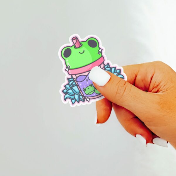 This image shows an hand-drawn adorable sticker, Frog Lotus Juice Sticker, which is available to purchase from HunnieByte.com