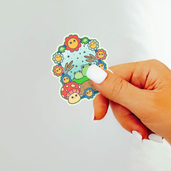 This image shows an hand-drawn adorable sticker, Frog Paradise Sticker, which is available to purchase from HunnieByte.com