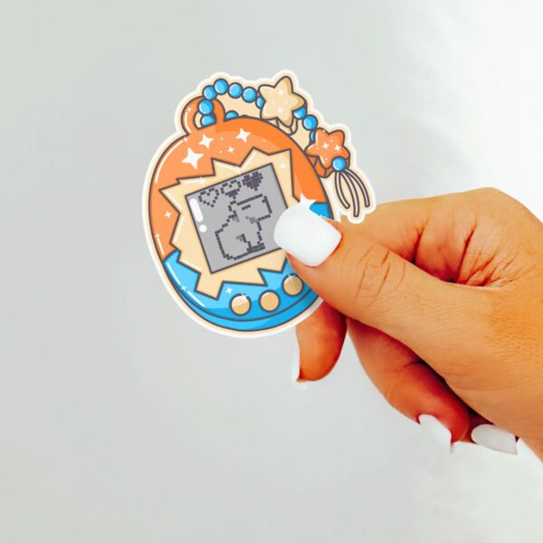 This image shows an hand-drawn adorable sticker, Pet Capybara Game Sticker, which is available to purchase from HunnieByte.com