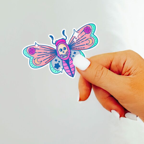 This image shows our adorable sticker finishes, Pastel Deaths Head Moth Sticker, which is available to purchase from HunnieByte.com