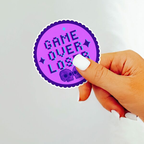 This image shows our adorable sticker finishes, Game Over Loser Sticker, which is available to purchase from HunnieByte.com