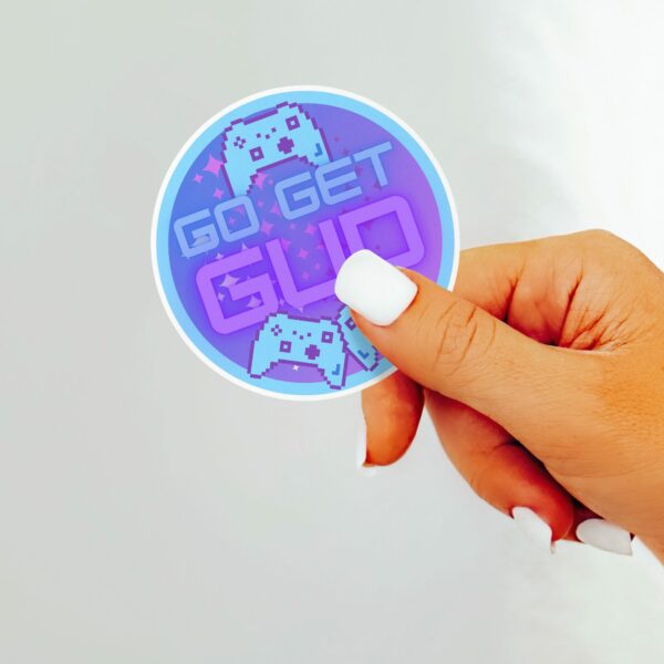 This image shows our adorable sticker finishes, Go Get Gud Gamer Sticker, which is available to purchase from HunnieByte.com