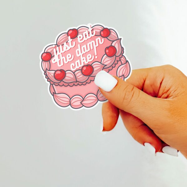 This image shows our adorable sticker finishes, Just Eat The Damn Cake Sticker, which is available to purchase from HunnieByte.com