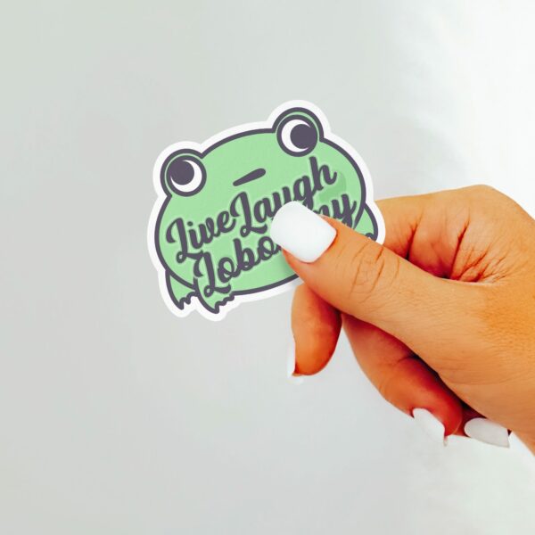 This image shows our adorable sticker finishes, Live Laugh Lobotomy Frog Sticker, which is available to purchase from HunnieByte.com