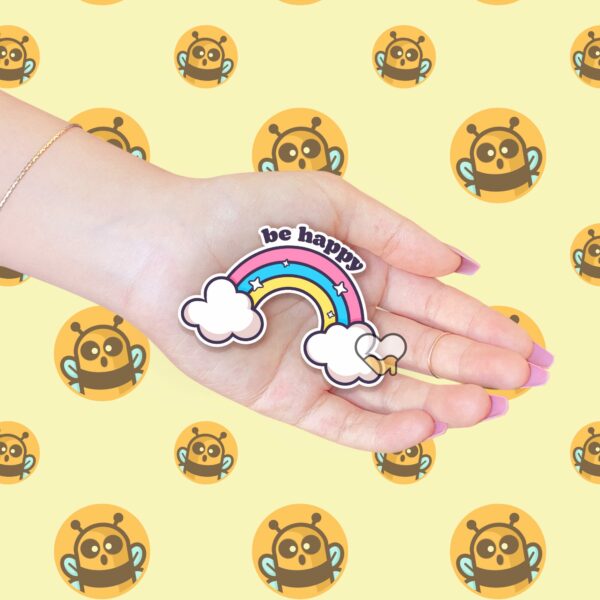 This image shows an hand-drawn adorable sticker, Be Happy Rainbow Sticker, which is available to purchase from HunnieByte.com