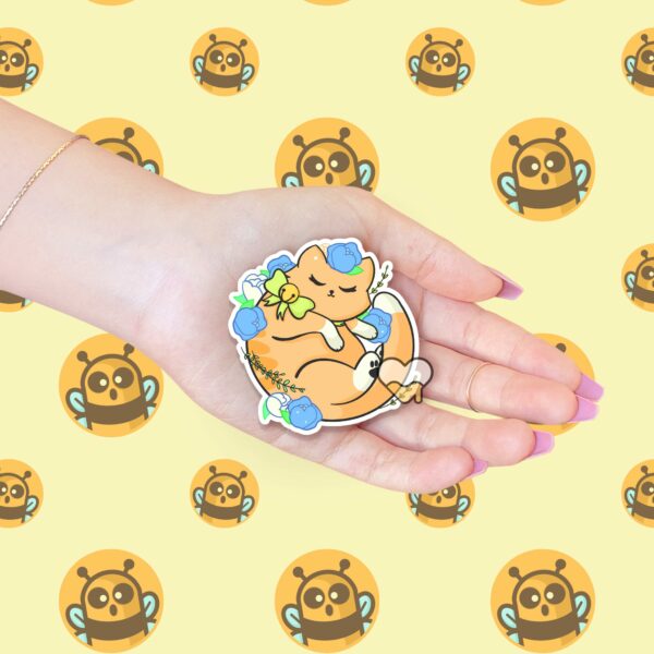 This image shows an hand-drawn adorable sticker, Floral Orange Kitty Sticker, which is available to purchase from HunnieByte.com