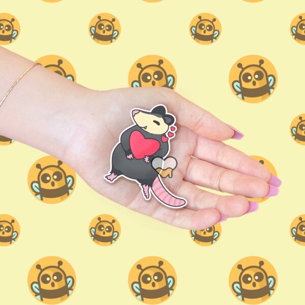 This image shows an hand-drawn adorable sticker, Sweet Possum Love Sticker, which is available to purchase from HunnieByte.com