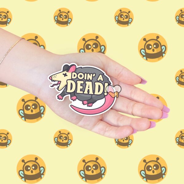 This image shows our adorable sticker finishes, Doin A Dead Possum Sticker, which is available to purchase from HunnieByte.com