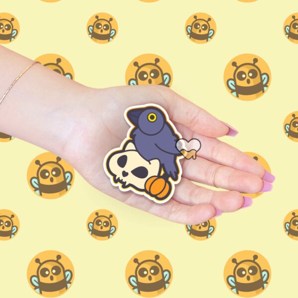 This image shows an hand-drawn adorable sticker, Crow and Skull Sticker, which is available to purchase from HunnieByte.com