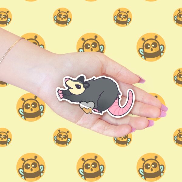 This image shows an hand-drawn adorable sticker, Stretchy Possum Sticker, which is available to purchase from HunnieByte.com