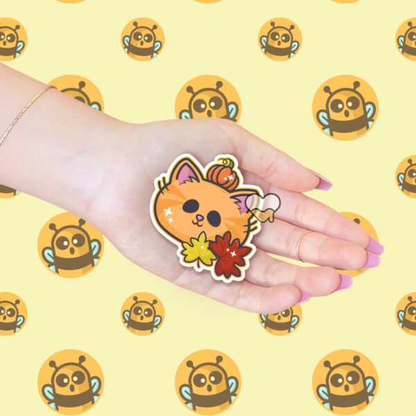 This image shows an hand-drawn adorable sticker, Autumn Pumpkin Kitty Sticker, which is available to purchase from HunnieByte.com