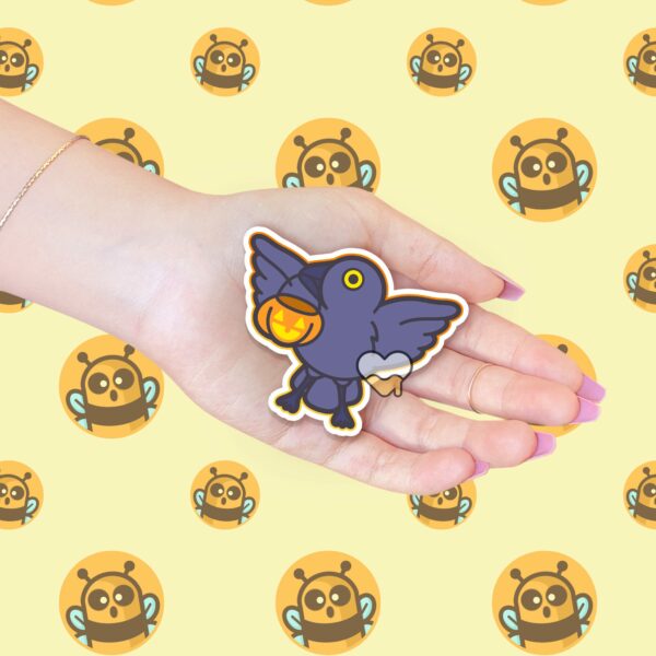 This image shows an hand-drawn adorable sticker, Crow and Pumpkin Sticker, which is available to purchase from HunnieByte.com