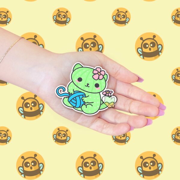 This image shows an hand-drawn adorable sticker, Cacticat with Yarn Sticker, which is available to purchase from HunnieByte.com