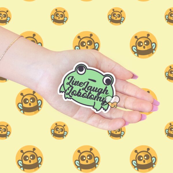 This image shows our adorable sticker finishes, Live Laugh Lobotomy Frog Sticker, which is available to purchase from HunnieByte.com