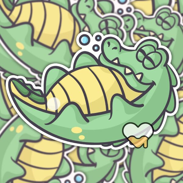 This image shows an hand-drawn adorable sticker, Lenny The Gator Sleeping Sticker, which is available to purchase from HunnieByte.com