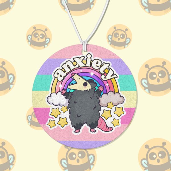 This image shows an adorable hand-drawn air freshener, Anxiety Rainbow Possum Air Freshener, which is available to purchase from HunnieByte.com