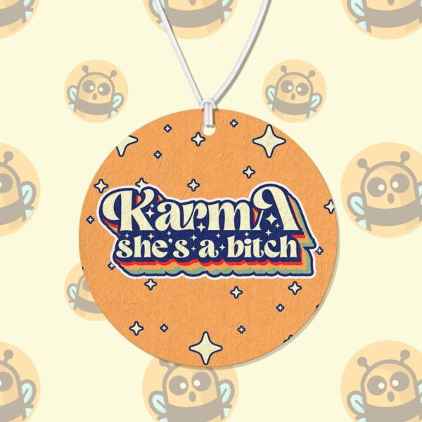 This image shows a hand-drawn adorable air freshener, Karma Shes A Bitch Air Freshener, which is available to purchase from HunnieByte.com