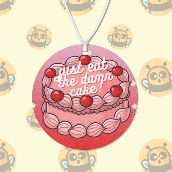 This image shows a hand-drawn adorable air freshener, Just Eat The Damn Cake Air Freshener, which is available to purchase from HunnieByte.com