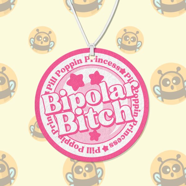 This image shows an adorable hand-drawn air freshener, Bipolar Bitch Pink Air Freshener, which is available to purchase from HunnieByte.com